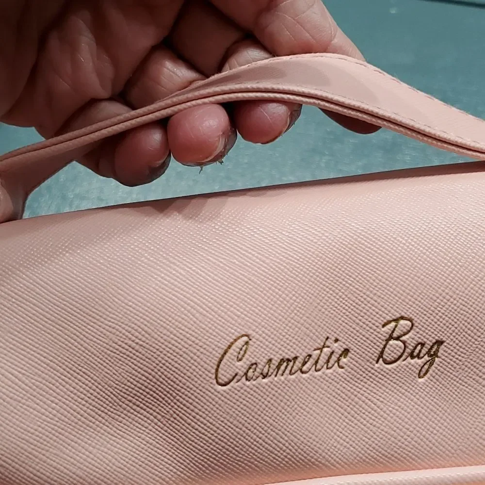 Two cosmetic bags.‎ One in vintage and homemade. The other is pink and la…